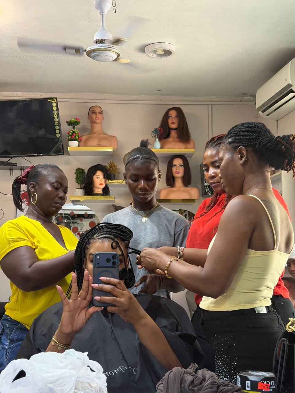 Client getting hair braided